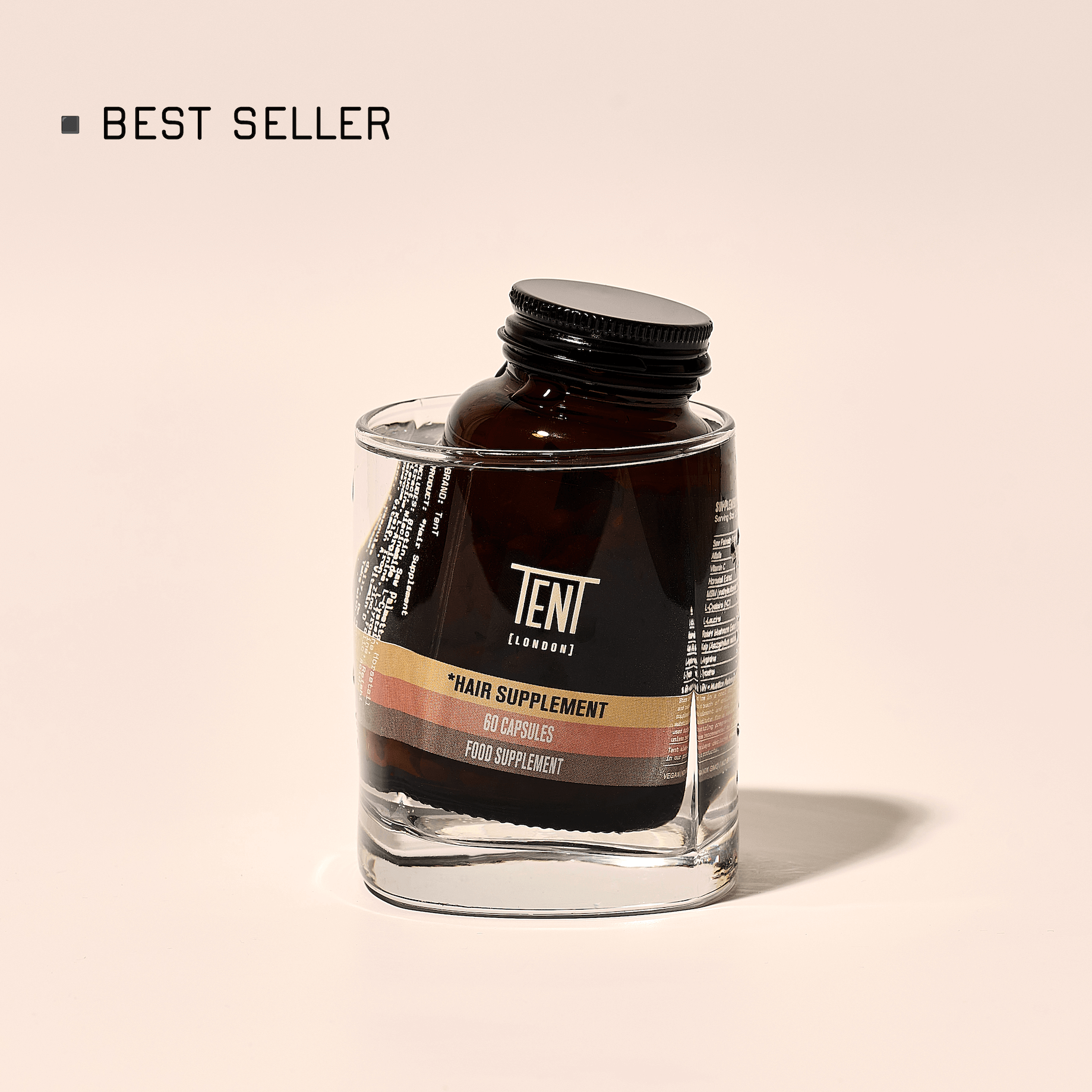 Hair supplement bottle with 'TENT' label on a beige background